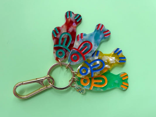 Colorful keychain with fish shapes on a green background